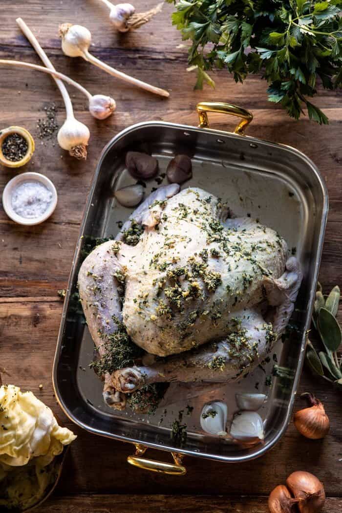 Herb and Butter Roasted Turkey with White Wine Pan Gravy | halfbakedharvest.com #turkey #thanksgiving overhead photo of Herb and Butter Roasted Turkey before adding cheesecloth and before roasting