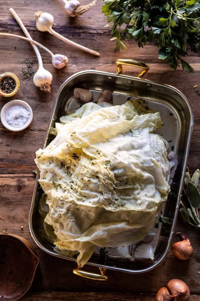 Herb and Butter Roasted Turkey with White Wine Pan Gravy | halfbakedharvest.com #turkey #thanksgiving overhead photo of Herb and Butter Roasted Turkey with cheesecloth draped over turkey before roasting