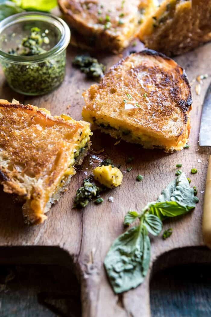 Breakfast Grilled Cheese with Soft Scrambled Eggs and Pesto | halfbakedharvest.com #breakfast #brunch #grilledcheese front on photo of Breakfast Grilled Cheese with Soft Scrambled Eggs and Pesto with basil