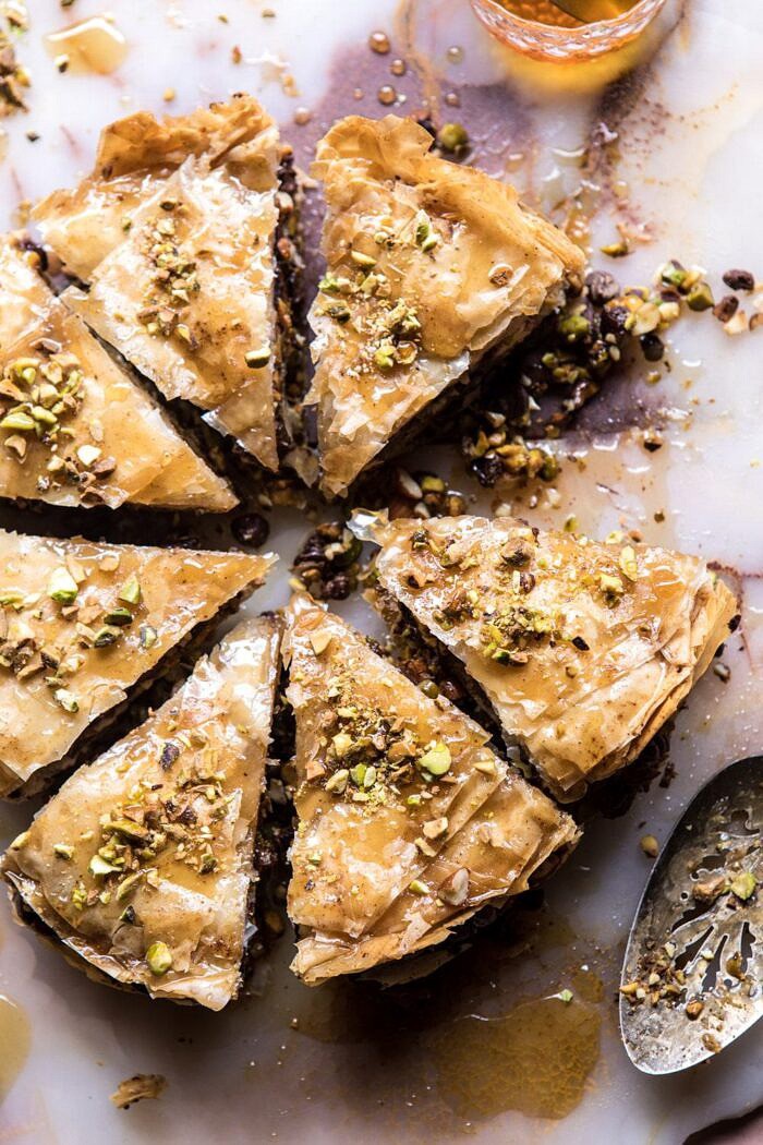 Easy Pistachio Chocolate Baklava | halfbakedharvest.com #greek #easydessert #chocolate overhead photo of Easy Pistachio Chocolate Baklava with piece missing