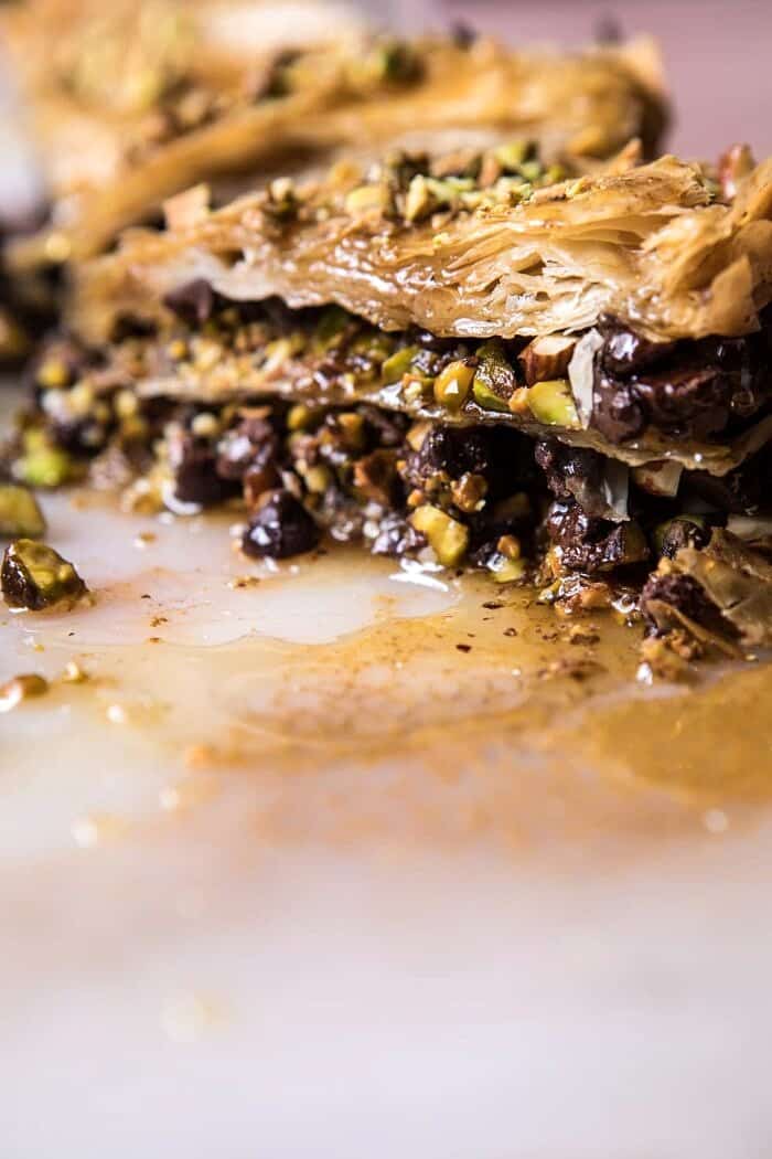 Easy Pistachio Chocolate Baklava | halfbakedharvest.com #greek #easydessert #chocolate side angle photo of cut into Easy Pistachio Chocolate Baklava