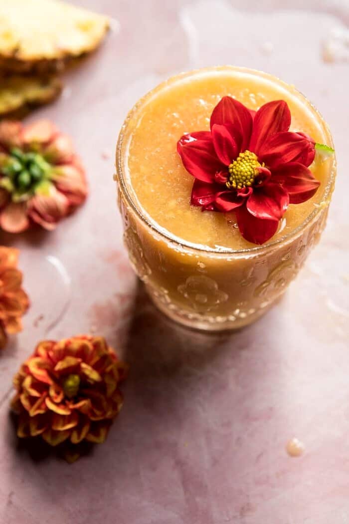 Frozen Brunch Punch | halfbakedharvest.com #brunch #cocktails #easyrecipes close up photo of Frozen Brunch Punch with flowers