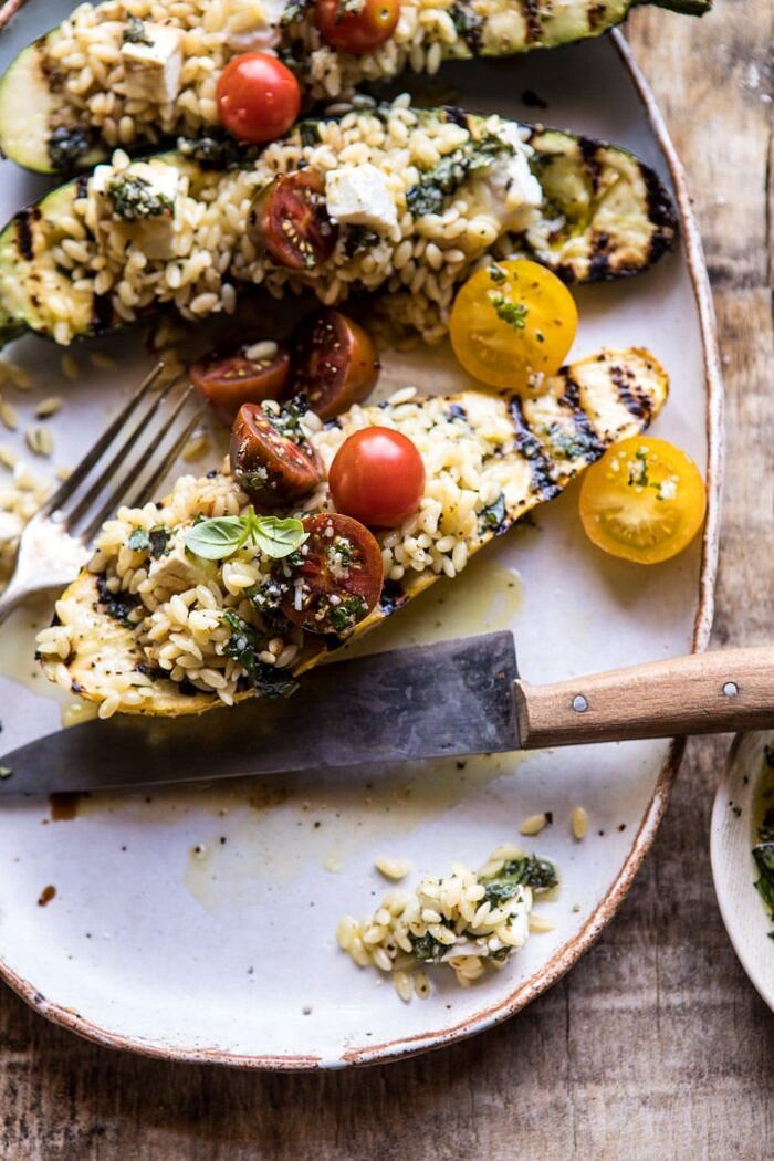 Grilled Pesto Zucchini Stuffed with Tomatoes and Orzo | halfbakedharvest.com #grilling #summer #easyrecipes cute into photo of Grilled Pesto Zucchini Stuffed with Tomatoes and Orzo