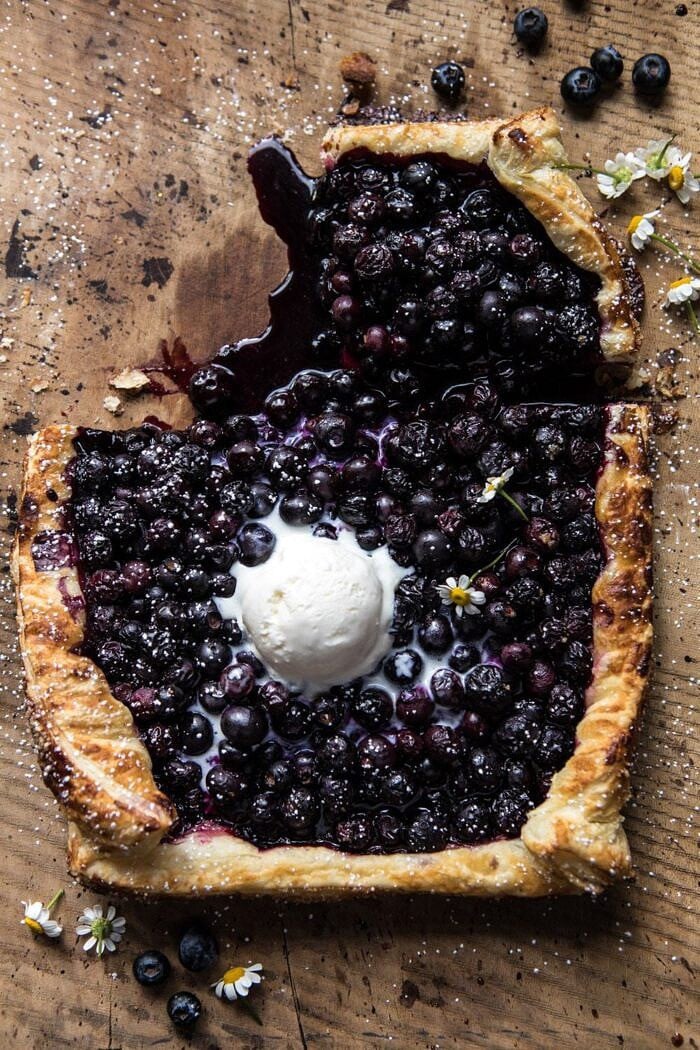 Blueberry Chamomile Galette | halfbakedharvest.com #blueberries #summer #easyrecipes overhead photo of Blueberry Chamomile Galette with piece missing