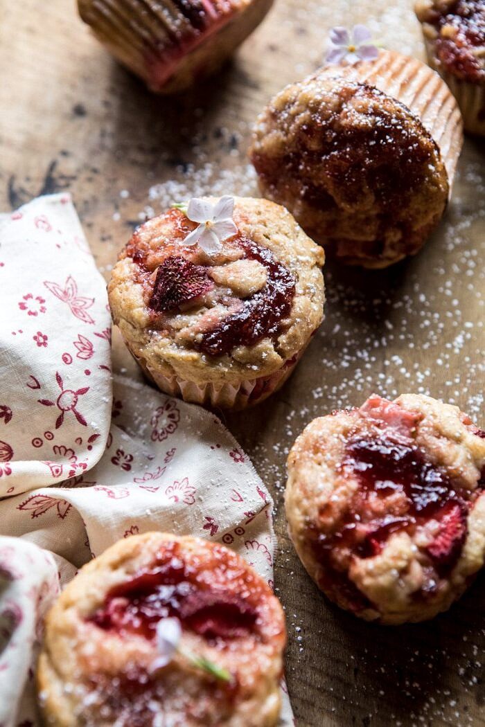 Honey Strawberry Muffins | halfbakedharvest.com #breakfast #summerrecipes #strawberries #muffins side angle photo of Honey Strawberry Muffins with flowers