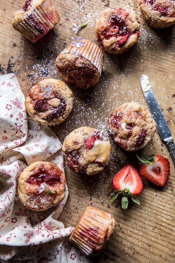 Honey Strawberry Muffins | halfbakedharvest.com #breakfast #summerrecipes #strawberries #muffins overhead photo of Honey Strawberry Muffins with butter knife