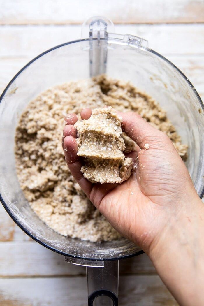 Buttery Raspberry Crumble Bars | halfbakedharvest.com #raspberry #dessert #summer #backtoschool #easyrecipes photo of crumb mix clumped together in hand