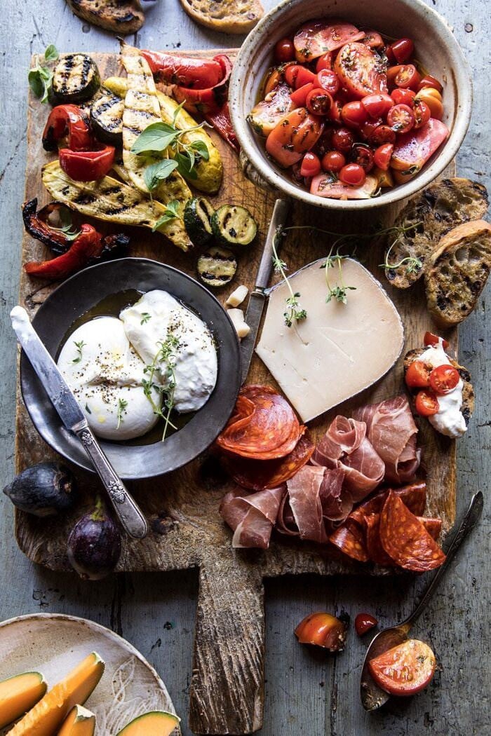 overhead photo of Marinated Tomato and Grilled Veggie Cheese Board with tomatoes on toast