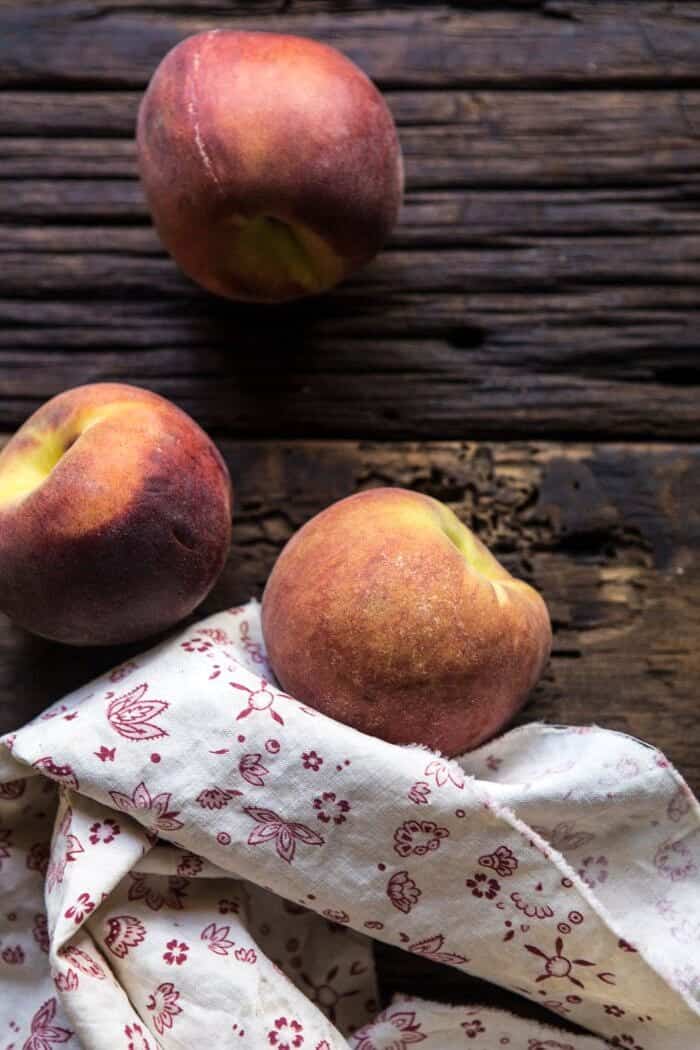 Skillet Balsamic Peach Pork Chops with Feta and Basil | halfbakedharvest.com #peaches #porkchops #easydinner #skilletrecipe overhead photo of raw peaches