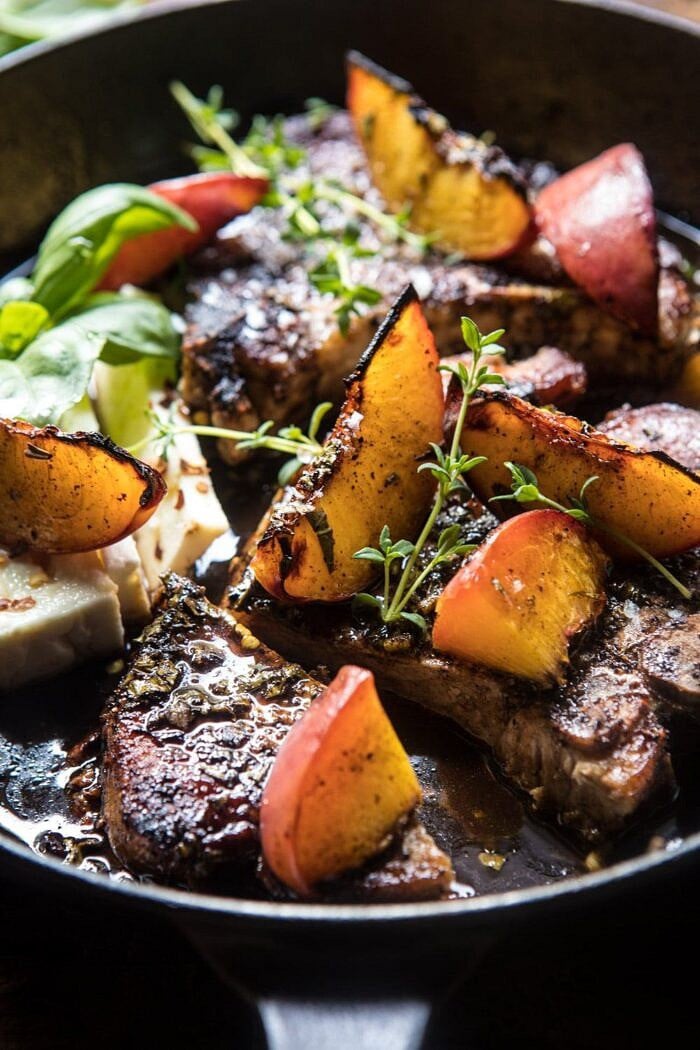Skillet Balsamic Peach Pork Chops with Feta and Basil | halfbakedharvest.com #peaches #porkchops #easydinner #skilletrecipe side angled photo of Skillet Balsamic Peach Pork Chops with Feta and Basil