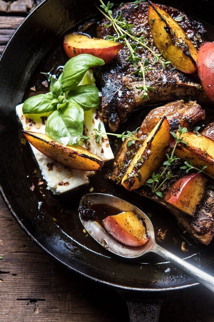 Skillet Balsamic Peach Pork Chops with Feta and Basil | halfbakedharvest.com #peaches #porkchops #easydinner #skilletrecipe overhead photo of Skillet Balsamic Peach Pork Chops with Feta and Basil and spoon in pan