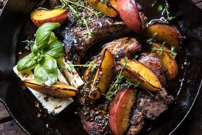 Skillet Balsamic Peach Pork Chops with Feta and Basil | halfbakedharvest.com #peaches #porkchops #easydinner #skilletrecipe overhead horizontal photo of Skillet Balsamic Peach Pork Chops with Feta and Basil