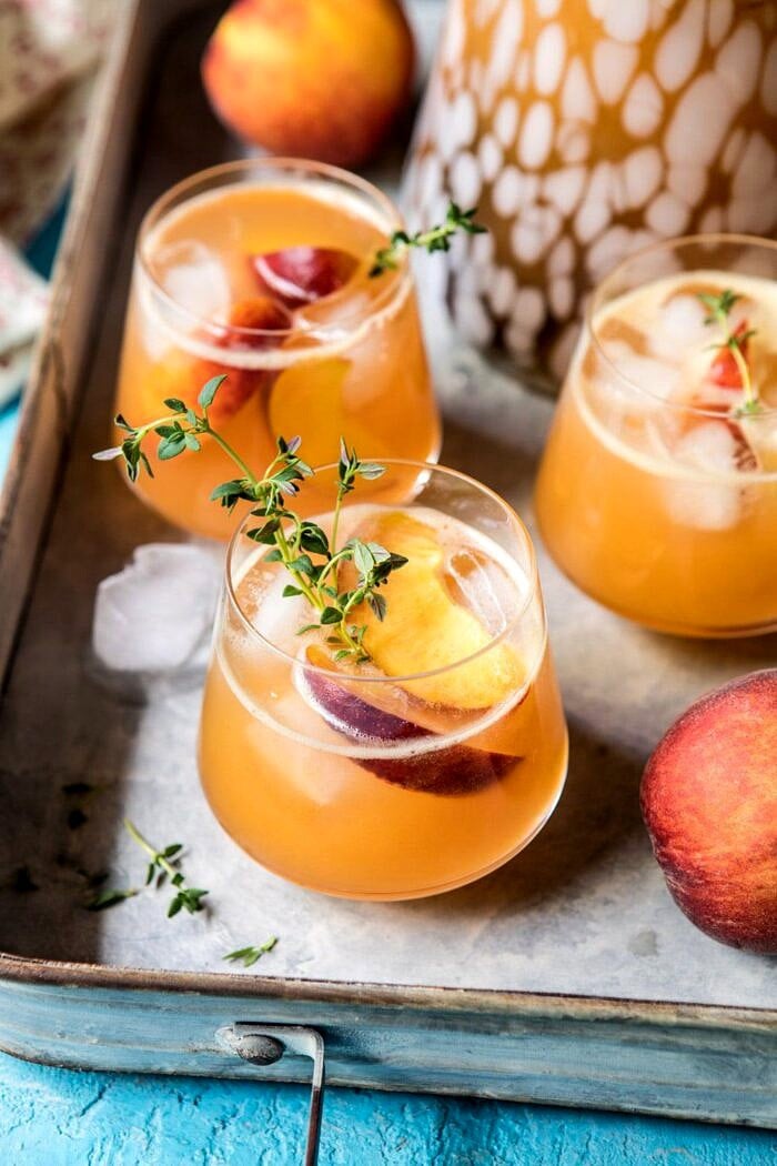 Sweet Bourbon Peach Lemonade | halfbakedharvest.com #peaches #bourbon #lemonade Sweet Bourbon Peach Lemonade on trey with peaches and pitcher