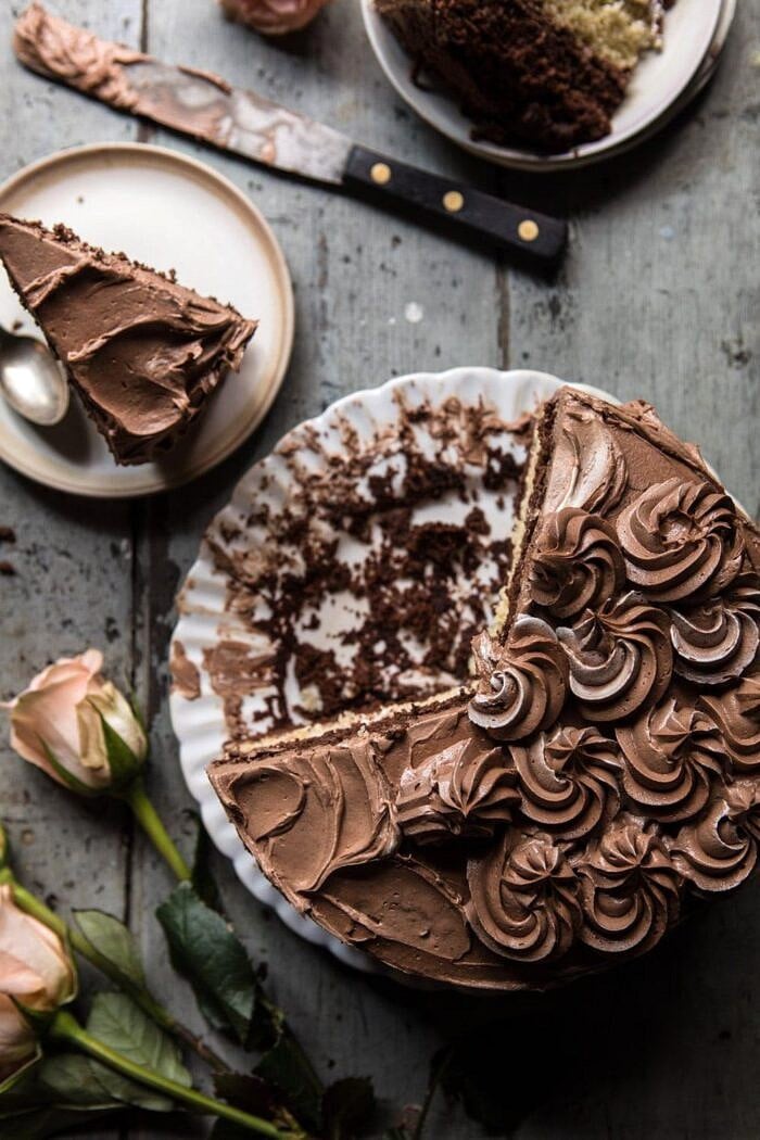 overhead photo of Better Together Chocolate Vanilla Birthday Cake with cake slices missing