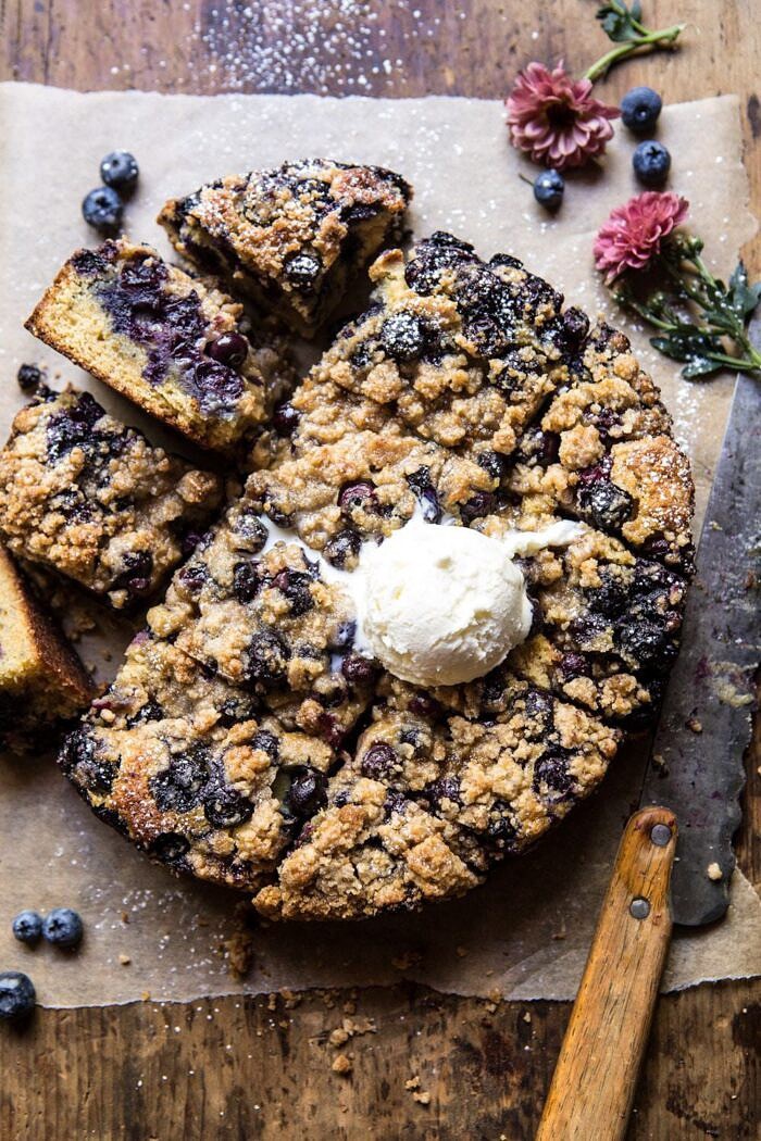 Bursting Blueberry Cardamom Buckle | halfbakedharvest.com #blueberry #cake #summerrecipes #easyrecipes #dessert overhead photo of Bursting Blueberry Cardamom Buckle with ice cream scoop on top