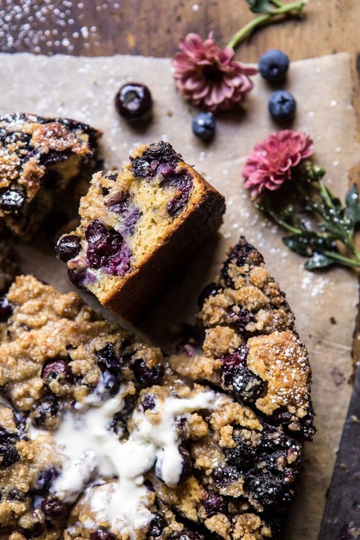 Bursting Blueberry Cardamom Buckle | halfbakedharvest.com #blueberry #cake #summerrecipes #easyrecipes #dessert close up photo of Bursting Blueberry Cardamom Buckle cake piece