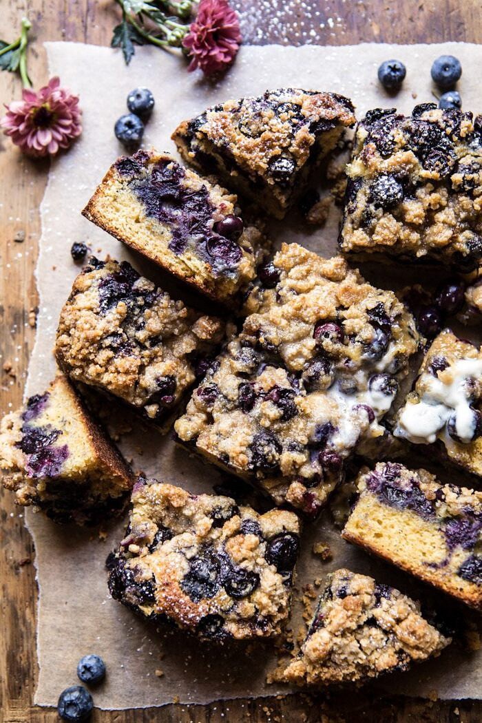 Bursting Blueberry Cardamom Buckle | halfbakedharvest.com #blueberry #cake #summerrecipes #easyrecipes #dessert overhead photo of Bursting Blueberry Cardamom Buckle with flowers in photo