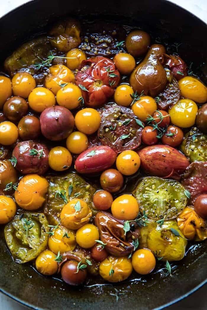 Caramelized Corn and Tomato Tarte Tatin | halfbakedharvest.com #simple #east #tomatoes #summer #tomatotart overhead photo of tomatoes in skillet
