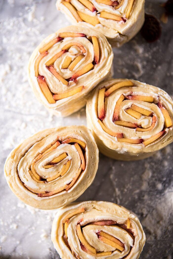Flaky Pull Apart Cinnamon Peach Brioche Bread | halfbakedharvest.com #bread #brunch #breakfast #peaches #summer #baking Flaky Pull Apart Cinnamon Peach Brioche rolls before baking, sliced on counter