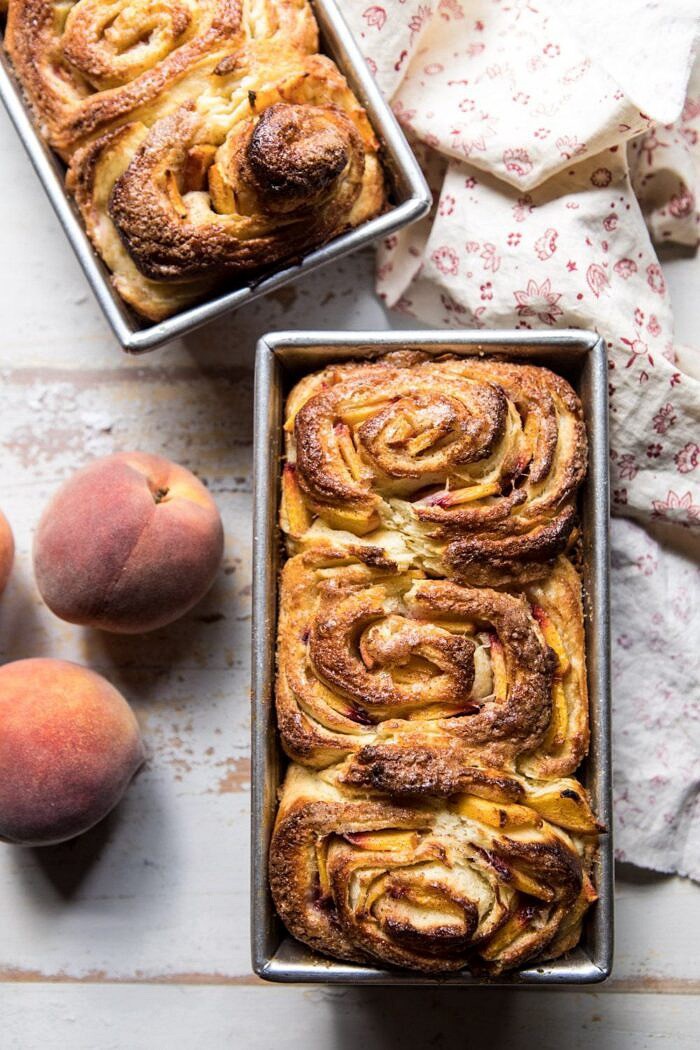 Flaky Pull Apart Cinnamon Peach Brioche Bread | halfbakedharvest.com #bread #brunch #breakfast #peaches #summer #baking overhead photo of Flaky Pull Apart Cinnamon Peach Brioche Bread on baking pans