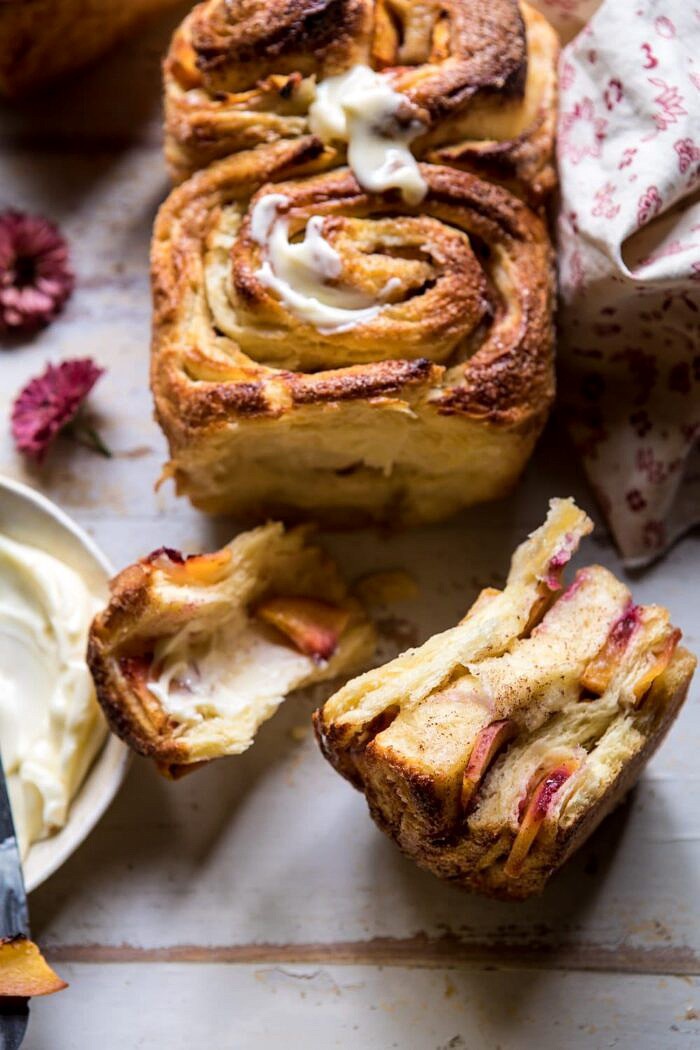 Flaky Pull Apart Cinnamon Peach Brioche Bread | halfbakedharvest.com #bread #brunch #breakfast #peaches #summer #baking side angled photo of Flaky Pull Apart Cinnamon Peach Brioche Bread
