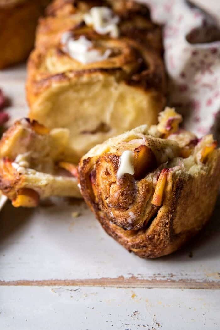 Flaky Pull Apart Cinnamon Peach Brioche Bread | halfbakedharvest.com #bread #brunch #breakfast #peaches #summer #baking front on photo of Flaky Pull Apart Cinnamon Peach Brioche Bread broken open