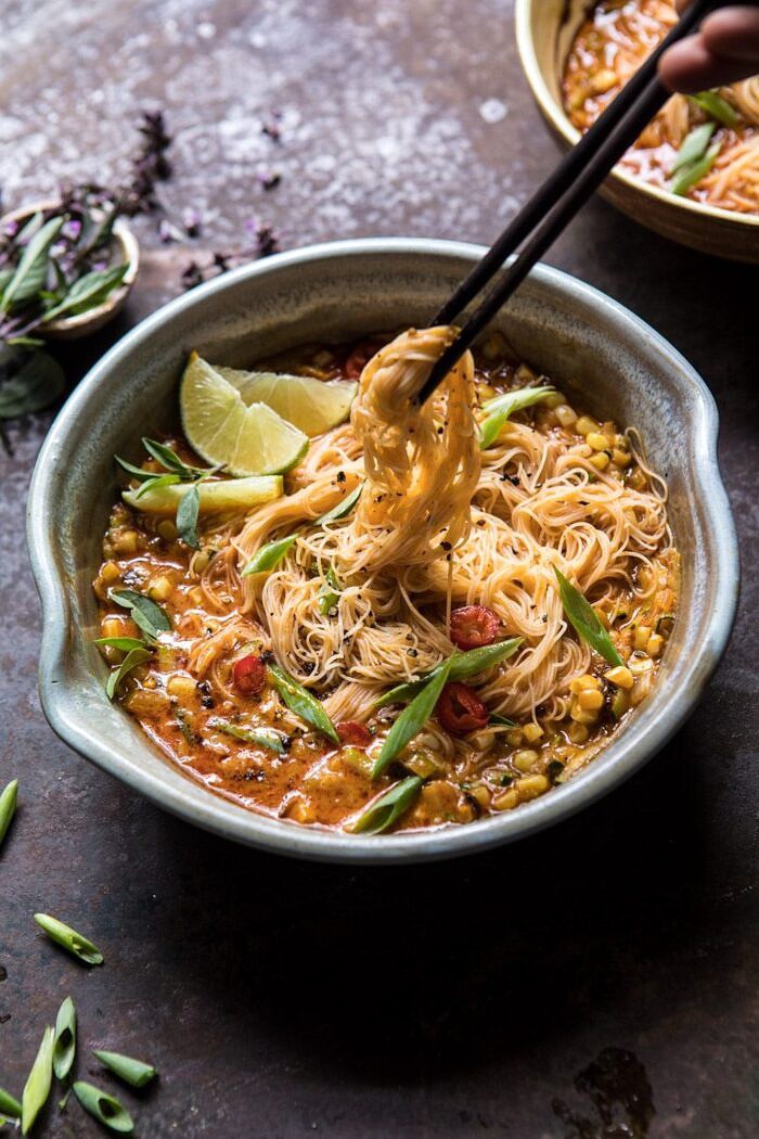 Saucy Coconut Summer Curry with Rice Noodles and Garden Vegetables | halfbakedharvest.com #curry #summerrecipes #easyrecipes #thairecipe #simplerecipes Saucy Coconut Curry with Rice Noodles and Garden Vegetables with chopsticks pulling up noodles