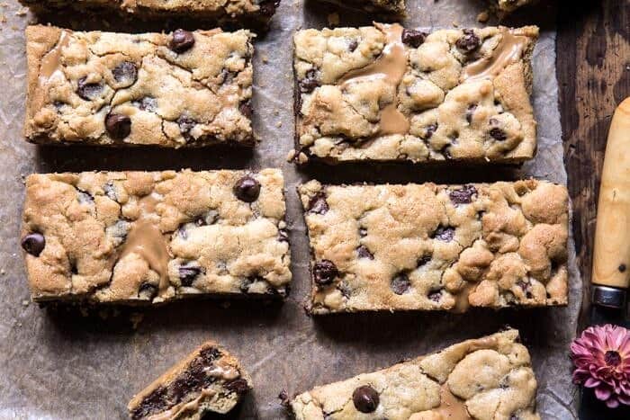 The Best Chocolate Chip Peanut Butter Swirled Cookie Bars | halfbakedharvest.com #cookies #cookiebars #peanutbutter #chocolate overhead horizontal photo of The Best Chocolate Chip Peanut Butter Swirled Cookie Bars
