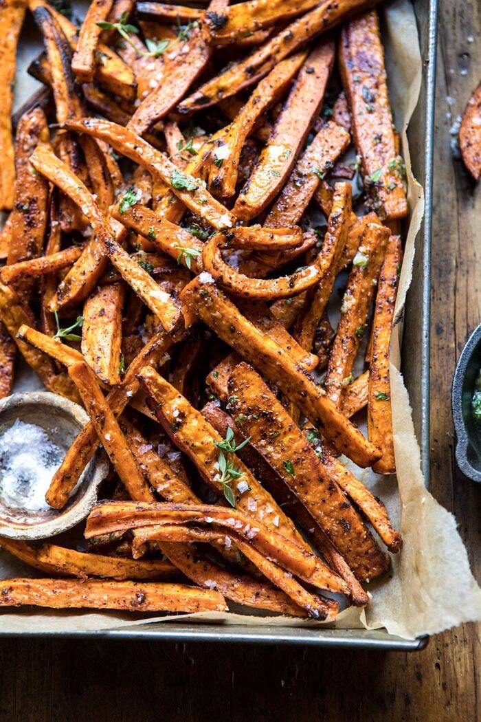 Herb Butter Baked Sweet Potato Fries | halfbakedharvest.com #quick #simple #easy #appetizers #sweetpotatoes #fallrecipes #autumn close up 3/4 angled photo of sweet potato fries