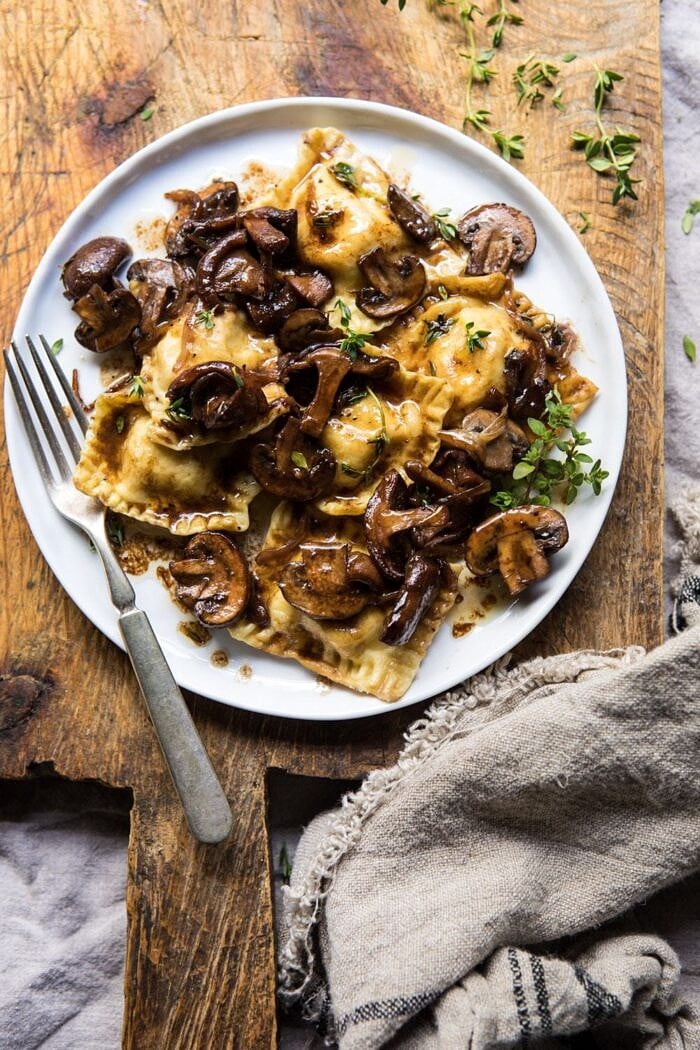 Herby Buttered Balsamic Mushroom Ravioli | halfbakedharvest.com #mushrooms #italian #ravioli #easyrecipes overhead photo of Herby Buttered Balsamic Mushroom Ravioli on plate with fork