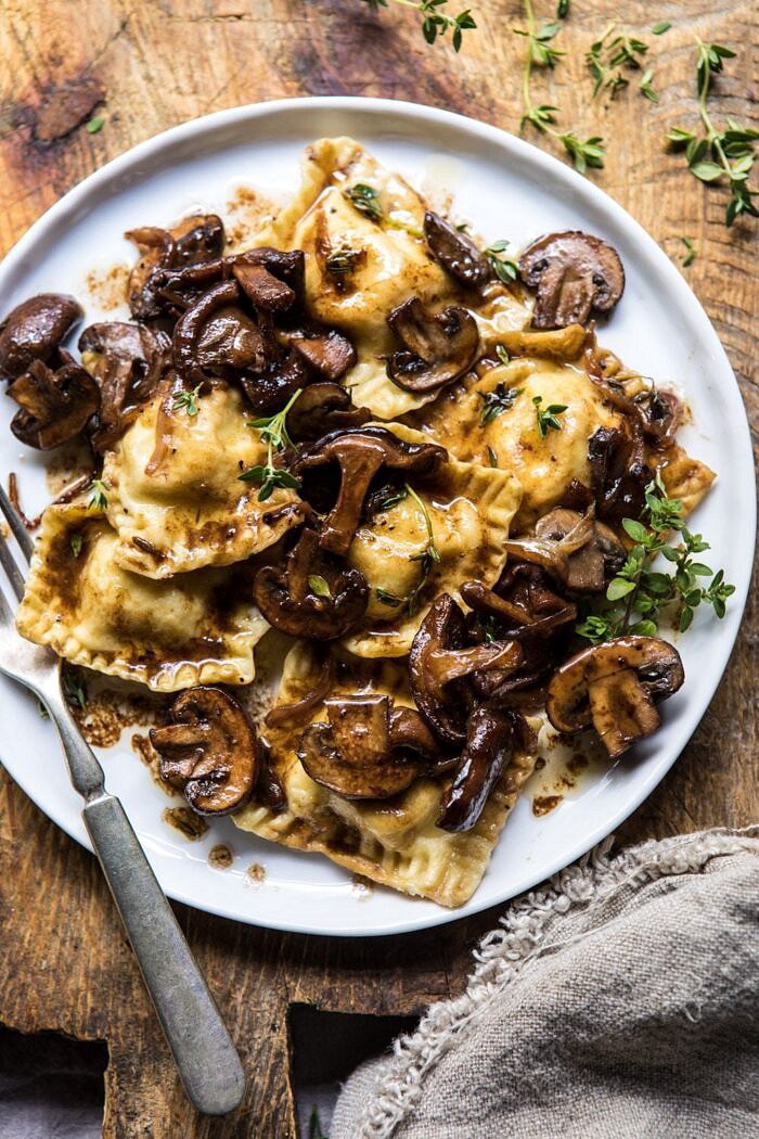 Herby Buttered Balsamic Mushroom Ravioli | halfbakedharvest.com #mushrooms #italian #ravioli #easyrecipes overhead, close up photo of Herby Buttered Balsamic Mushroom Ravioli on plate with fork