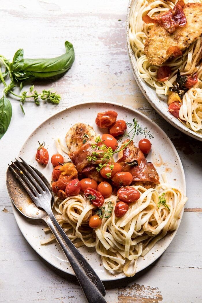 Prosciutto Chicken Parmesan with Garlic Butter Tomato Pasta | halfbakedharvest.com #pasta #easyrecipe #tomatoes #familyrecipes overhead photo of Prosciutto Chicken Parmesan with Garlic Butter Tomato Pasta on plate