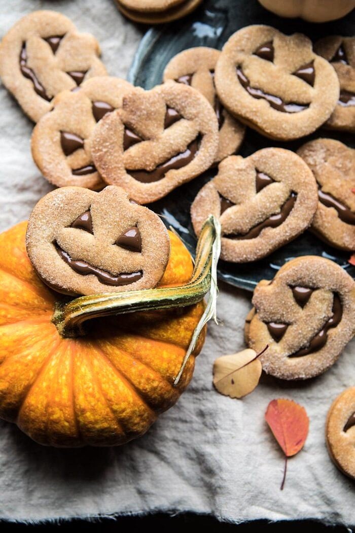 Milk Chocolate Stuffed Jack-O'-Lantern Cookies sitting on top of mini pumpkin