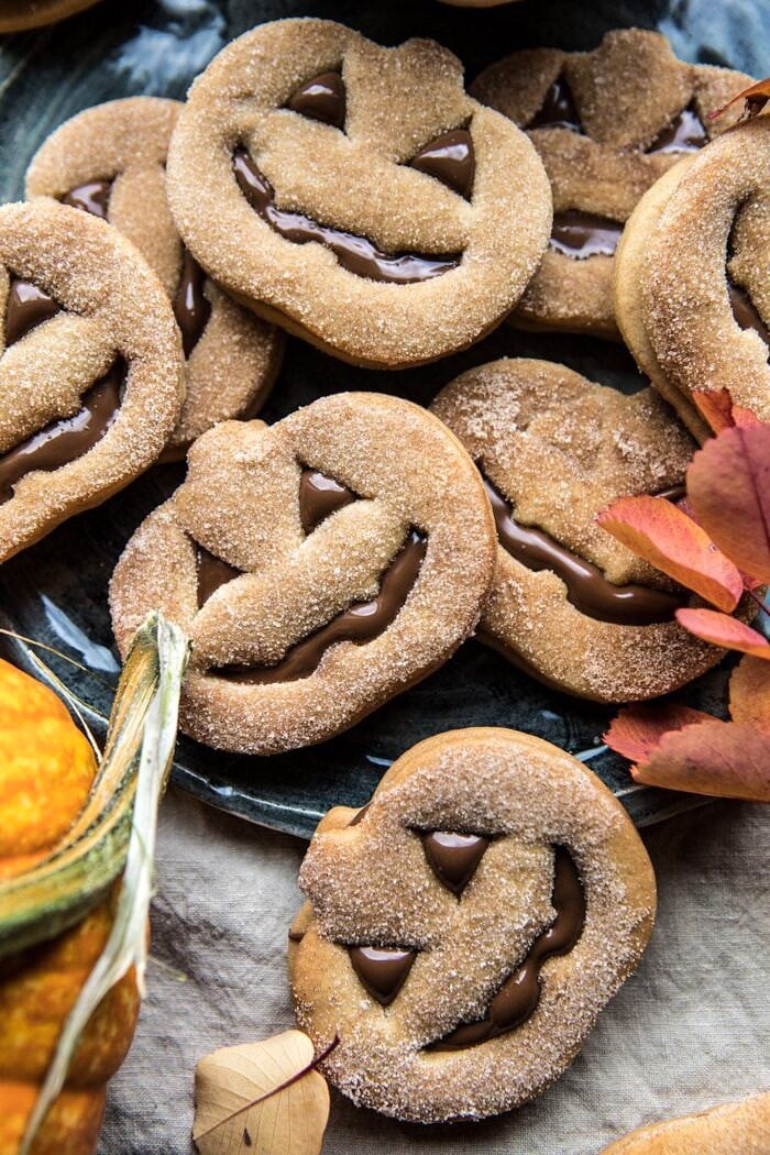 close up overhead photo of Milk Chocolate Stuffed Jack-O'-Lantern Cookies on plate