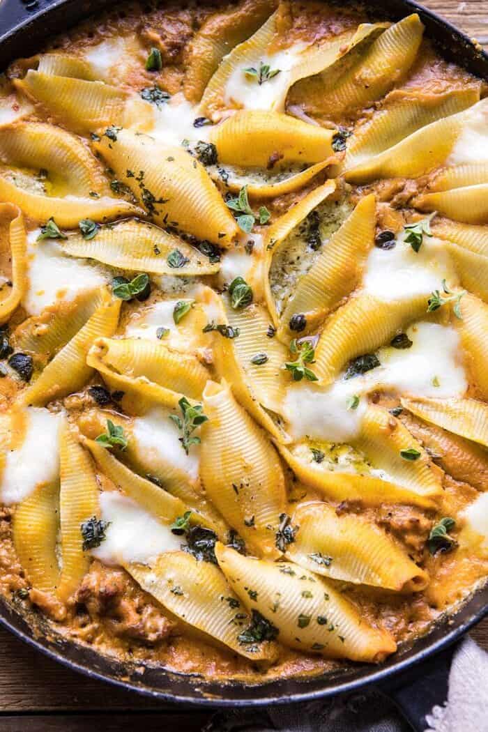 Spicy Pumpkin and Pesto Cheese Stuffed Shells | halfbakedharvest.com #pumpkin #pasta #Italian #easy #dinner #fall #fallrecipes overhead close up photo of Spicy Pumpkin and Pesto Cheese Stuffed Shells