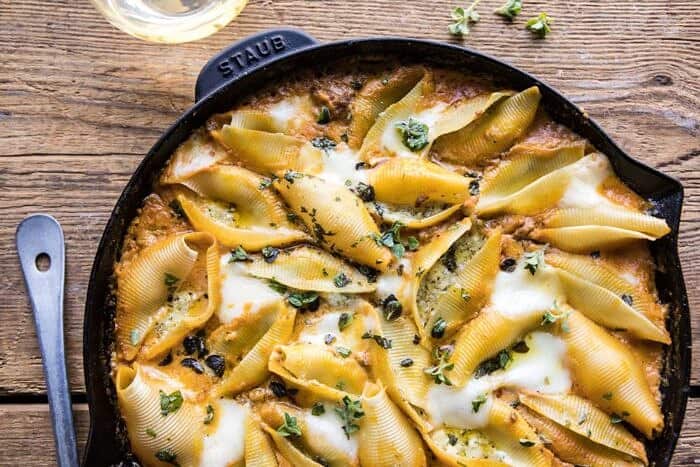Spicy Pumpkin and Pesto Cheese Stuffed Shells | halfbakedharvest.com #pumpkin #pasta #Italian #easy #dinner #fall #fallrecipes horizontal photo of Spicy Pumpkin and Pesto Cheese Stuffed Shells in skillet