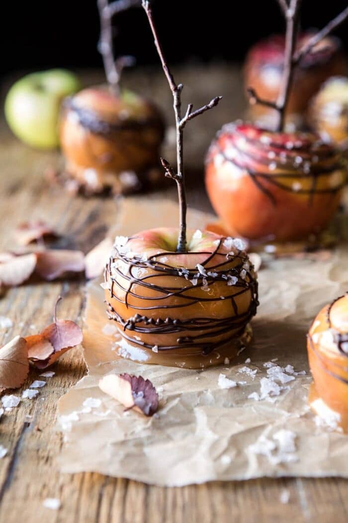 Sweet and Salty Chocolate Drizzled Cider Caramel Apples | halfbakedharvest.com #fallrecipes #apples #caramel #hallaween #thanksgiving close up photo of Sweet and Salty Chocolate Drizzled Cider Caramel Apples