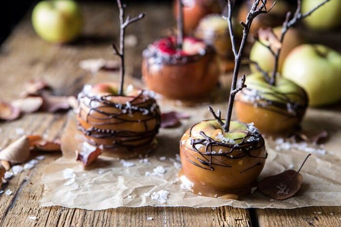 Sweet and Salty Chocolate Drizzled Cider Caramel Apples | halfbakedharvest.com #fallrecipes #apples #caramel #hallaween #thanksgiving horizontal front on photo of Sweet and Salty Chocolate Drizzled Cider Caramel Apples