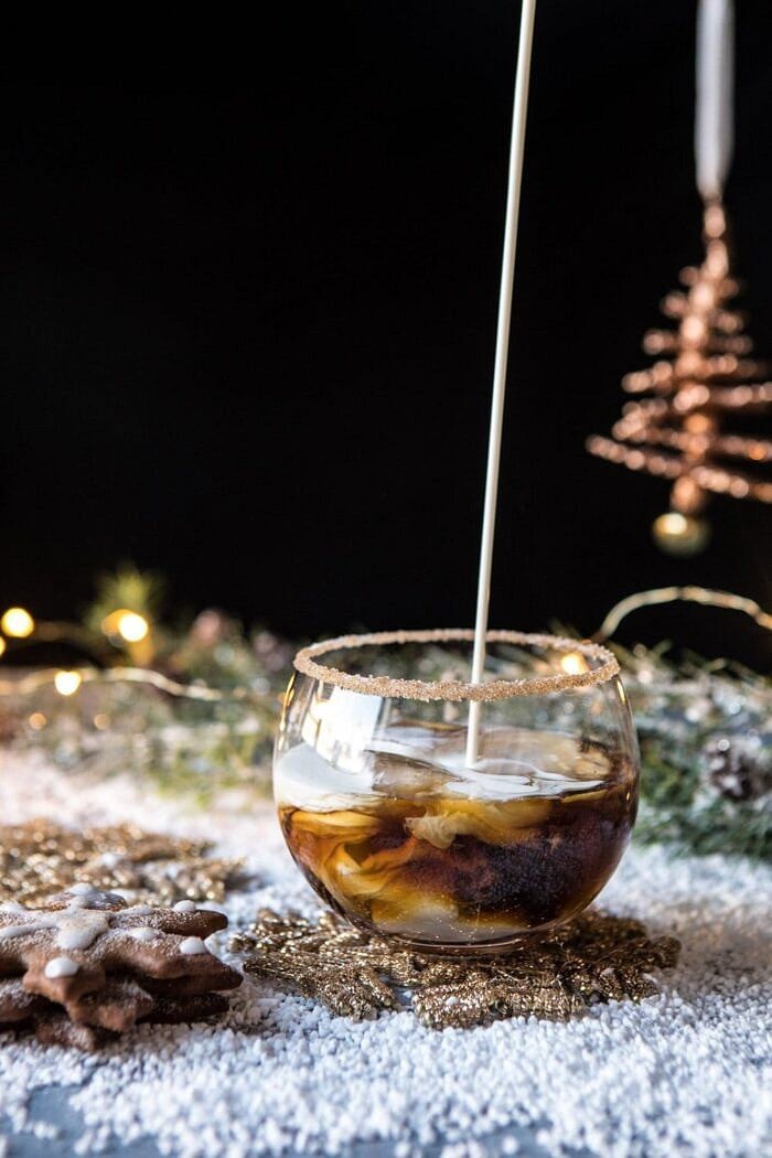 Gingerbread White Russian | halfbakedharvest.com #gingerbread #whiterussian #christmas #holiday #drink #cocktail cream being poured into Gingerbread White Russian