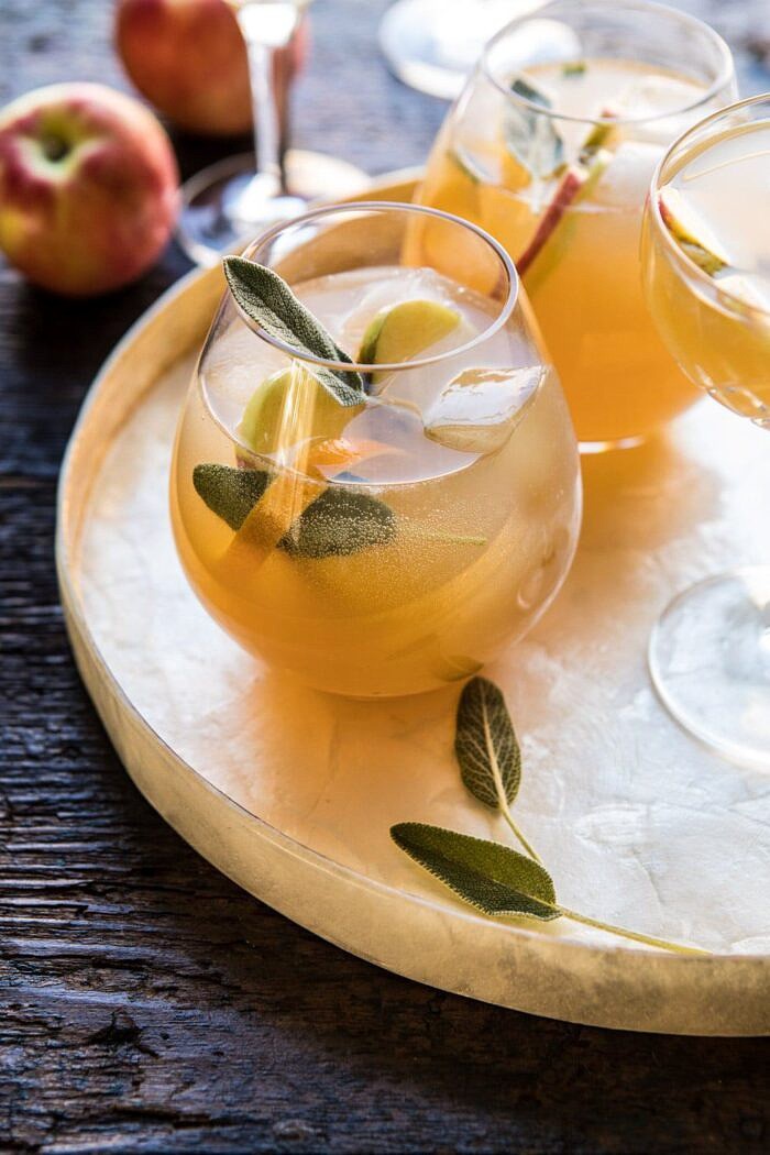 side angle photo Harvest Apple Ginger Spritz with apples and sage in photo 