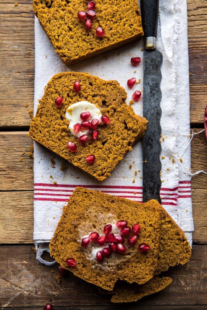 Healthy Pumpkin Ginger Bread | halfbakedharvest.com #healthy #pumpkin #bread #fall #thanksgiving #easyrecipes overhead photo of Healthy Pumpkin Ginger Bread slices with butter and pomegranates