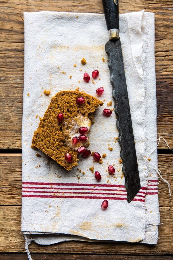 Healthy Pumpkin Ginger Bread | halfbakedharvest.com #healthy #pumpkin #bread #fall #thanksgiving #easyrecipes overhead photo of Healthy Pumpkin Ginger Bread slice with knife