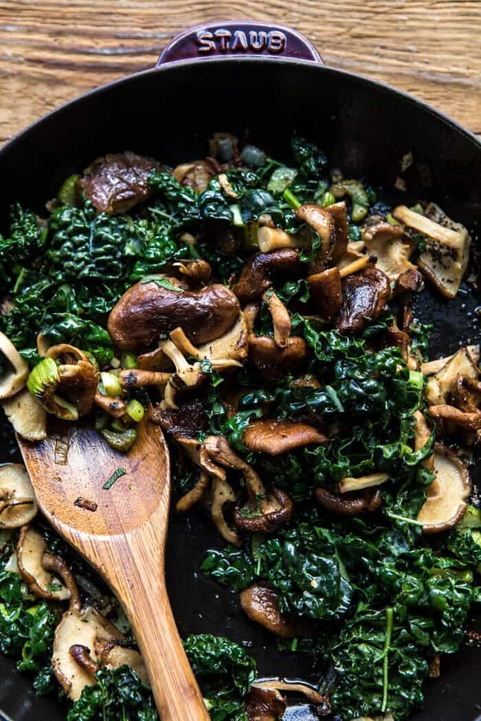 Herby Mushroom Croissant Stuffing | halfbakedharvest.com #stuffing #thanksgiving #easyrecipes #croissants mushrooms and kale in skillet