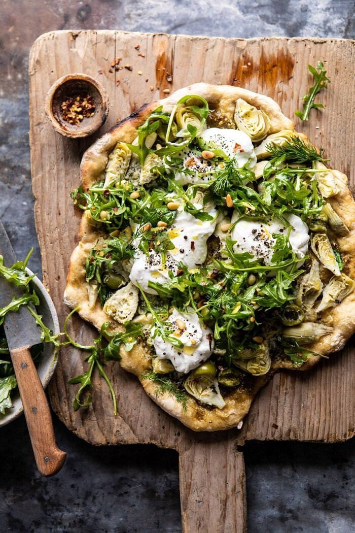 Artichoke Pesto and Burrata Pizza with Lemony Arugula before being cut