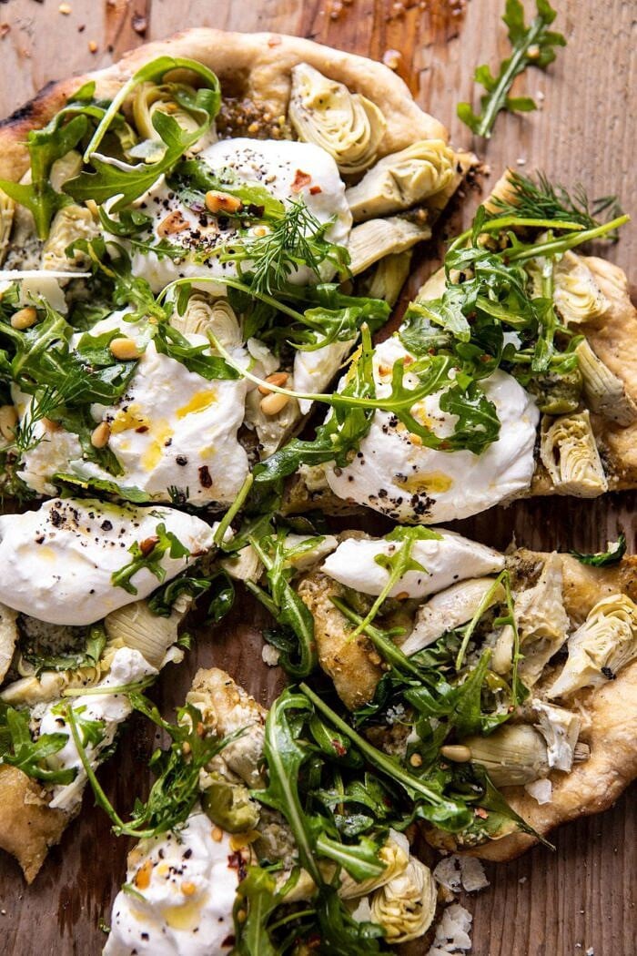 overhead close up photo of Artichoke Pesto and Burrata Pizza with Lemony Arugula 