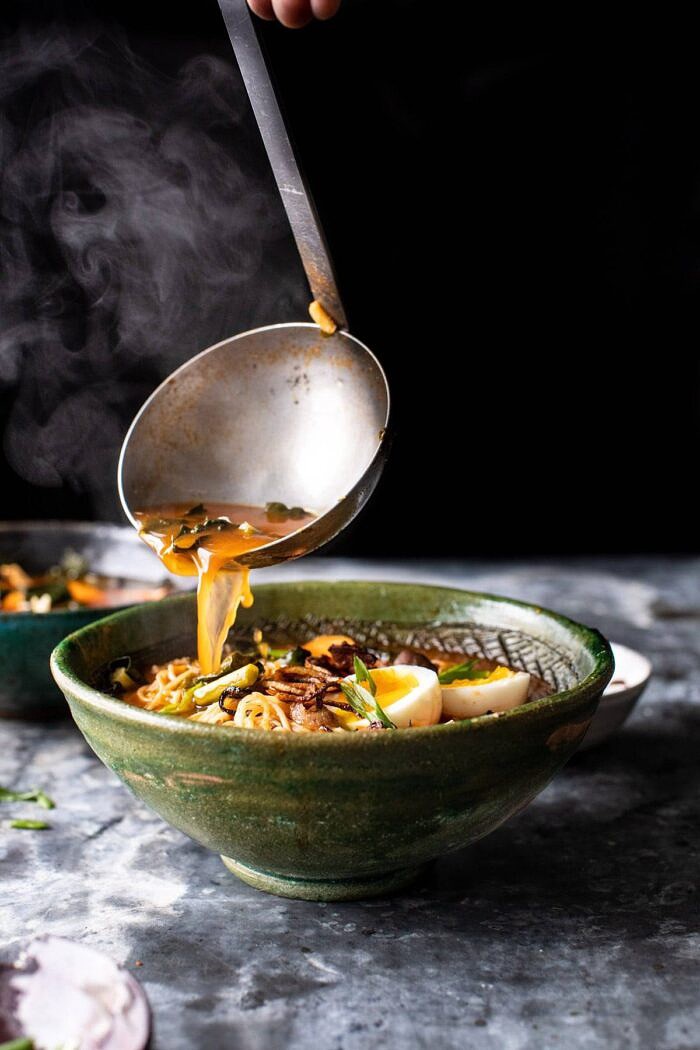 side angle photo of Feel Good Spicy Ramen begin poured into bowls