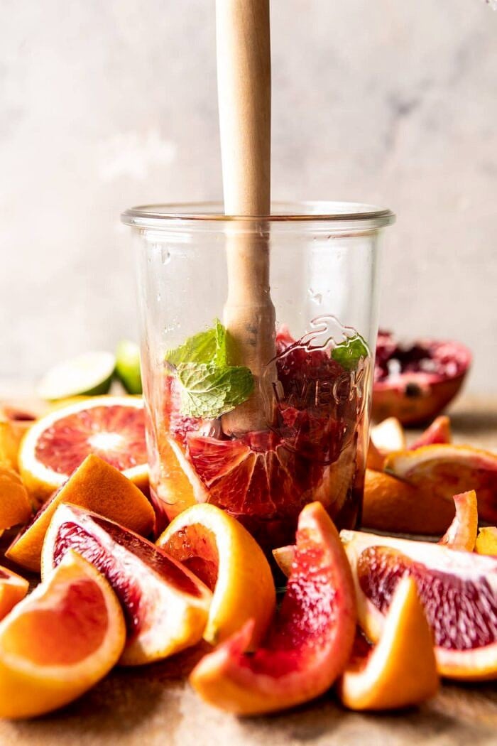 Winter Citrus Tequila Smash being muddled together