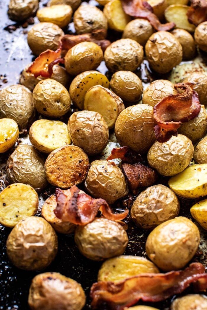 Crispy Breakfast Potatoes with Chili Garlic Oil and Herbs | halfbakedharvest.com #potatoes #breakfast #easyrecipes #brunch potatoes and bacon on baking sheet after roasting