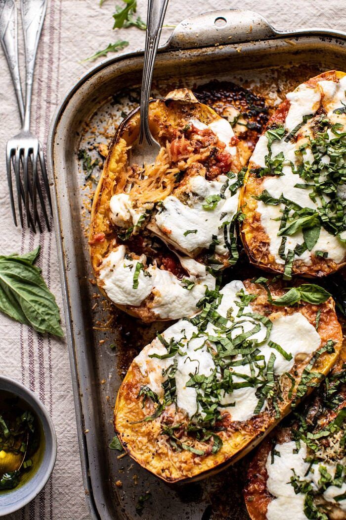 Spicy Tomato Parmesan Stuffed Spaghetti Squash with fork in squash pulling up noodles