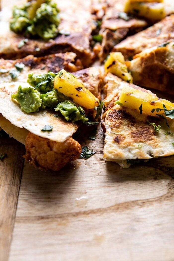 Cauliflower Al Pastor Quesadillas with Lime Smashed Avocado | halfbakedharvest.com #vegan #Mexican #cauliflower #pineapple #sandwich #easyrecipes #cheese side angled photo of Cauliflower Al Pastor Quesadillas with Lime Smashed Avocado